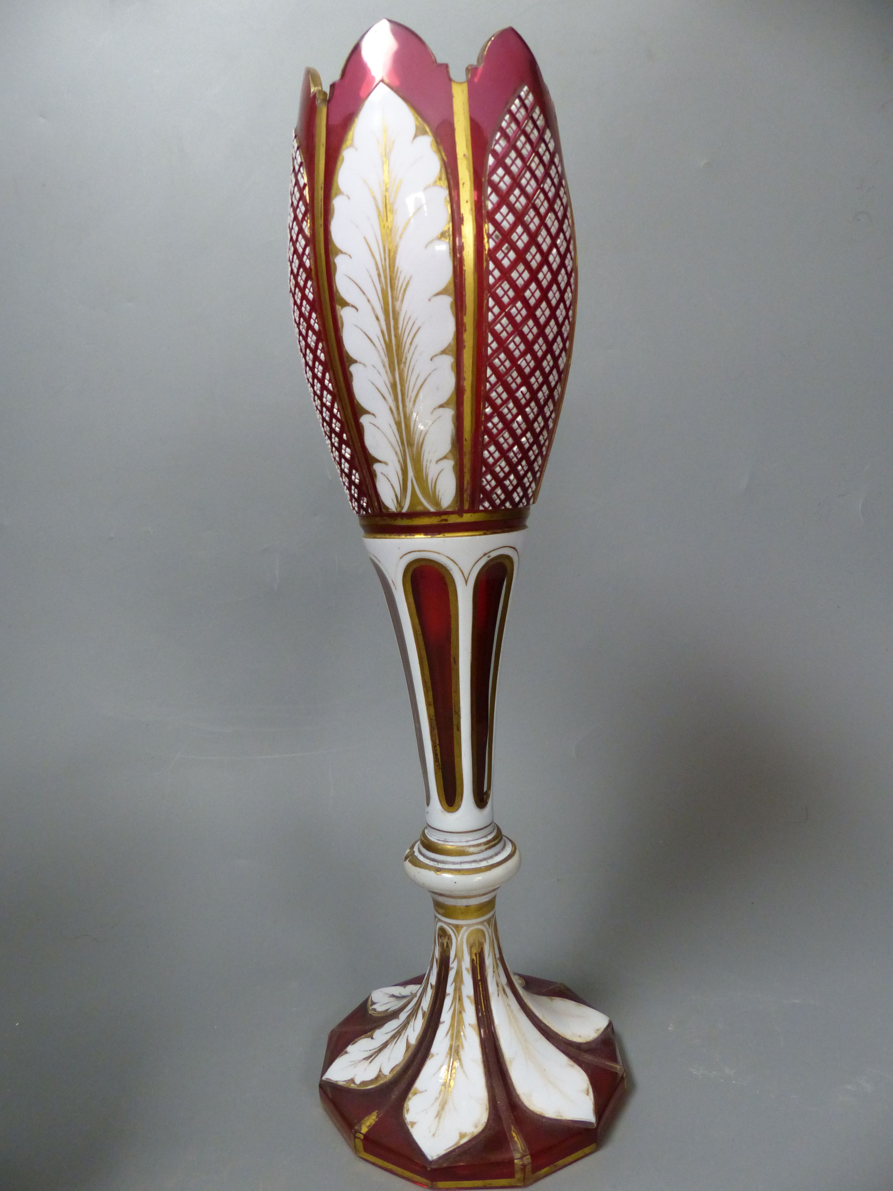 A Bohemian blue and white overlaid glass jug and a similar ruby and white overlaid glass vase, tallest 35cm